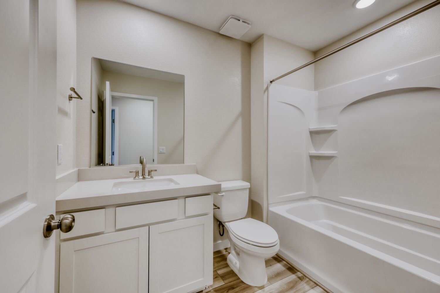 A bathroom with a tub sink and toilet.