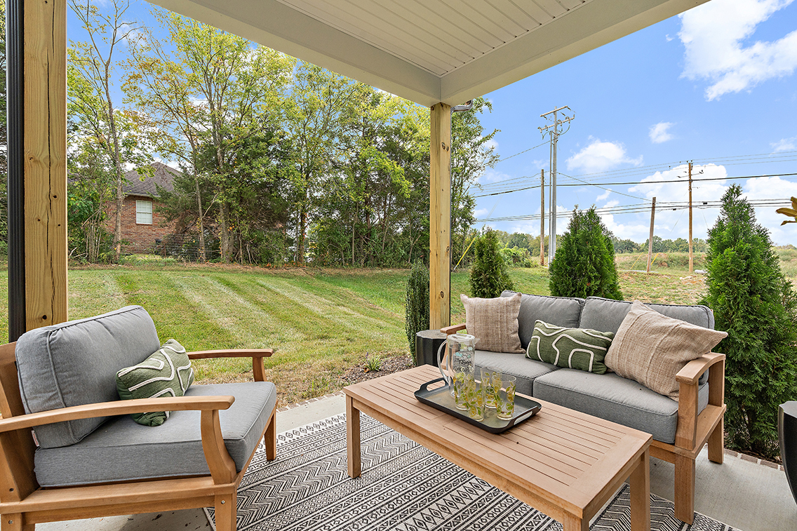 A patio with a table and chairs.