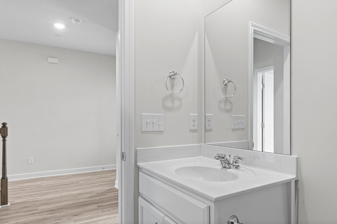 A bathroom with a large mirror.