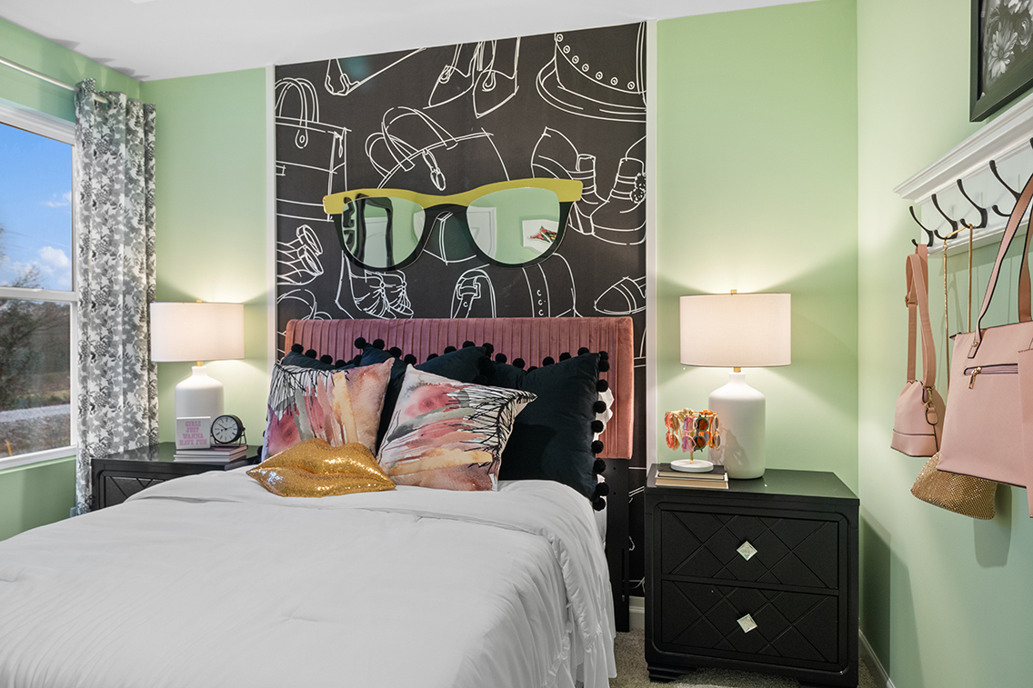 A bedroom with a large poster on the wall.