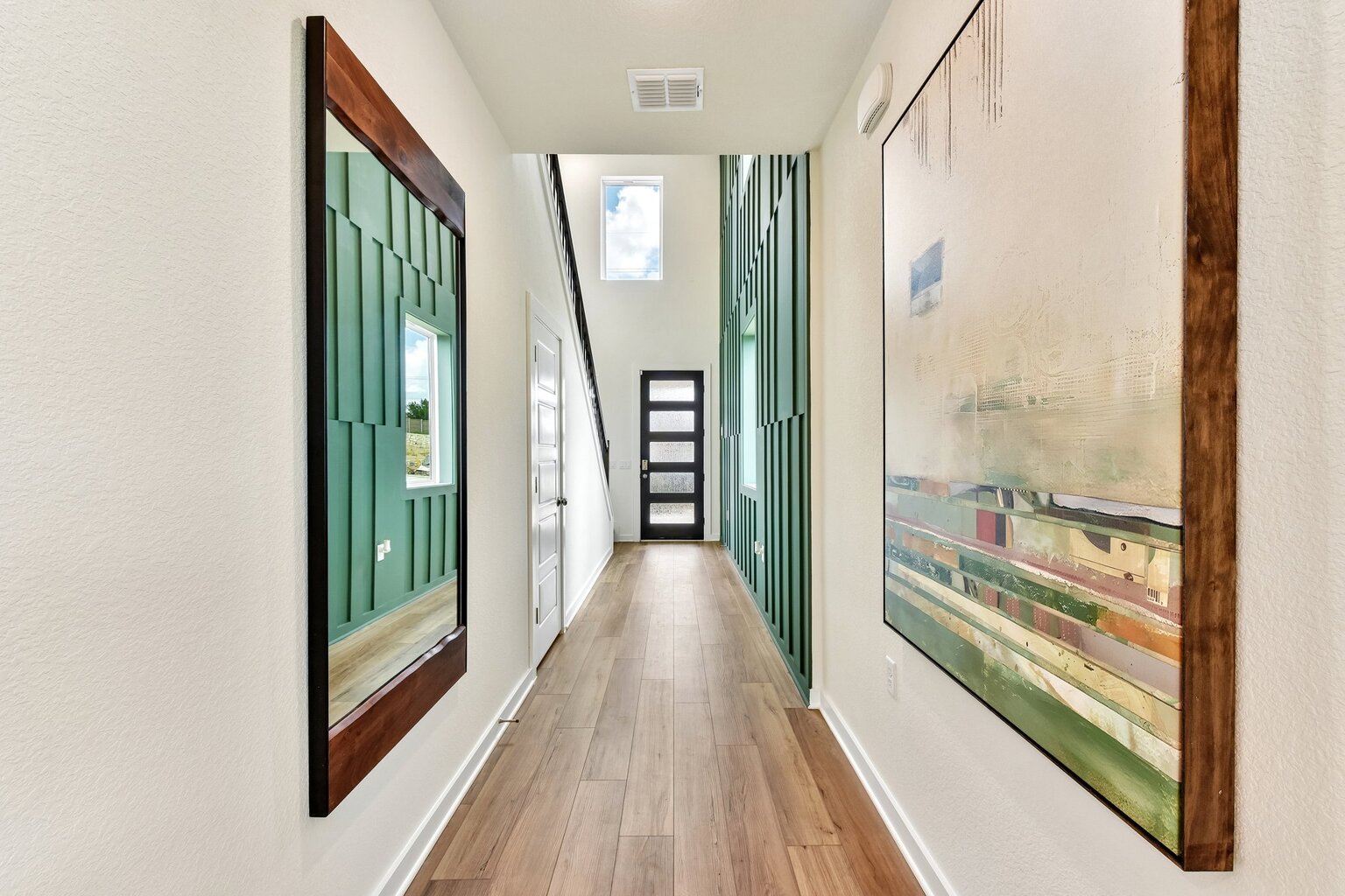 A hallway with green doors.