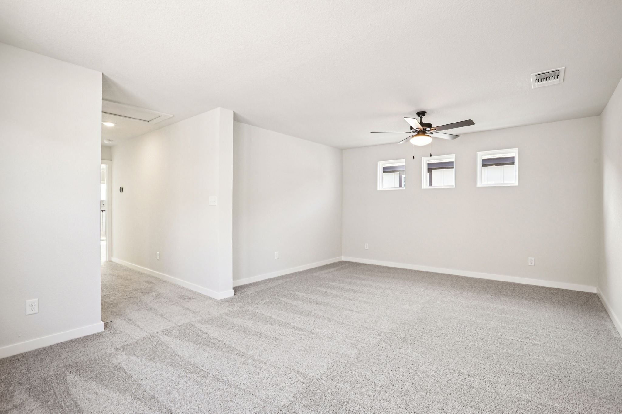 A room with a ceiling fan and a ceiling fan.
