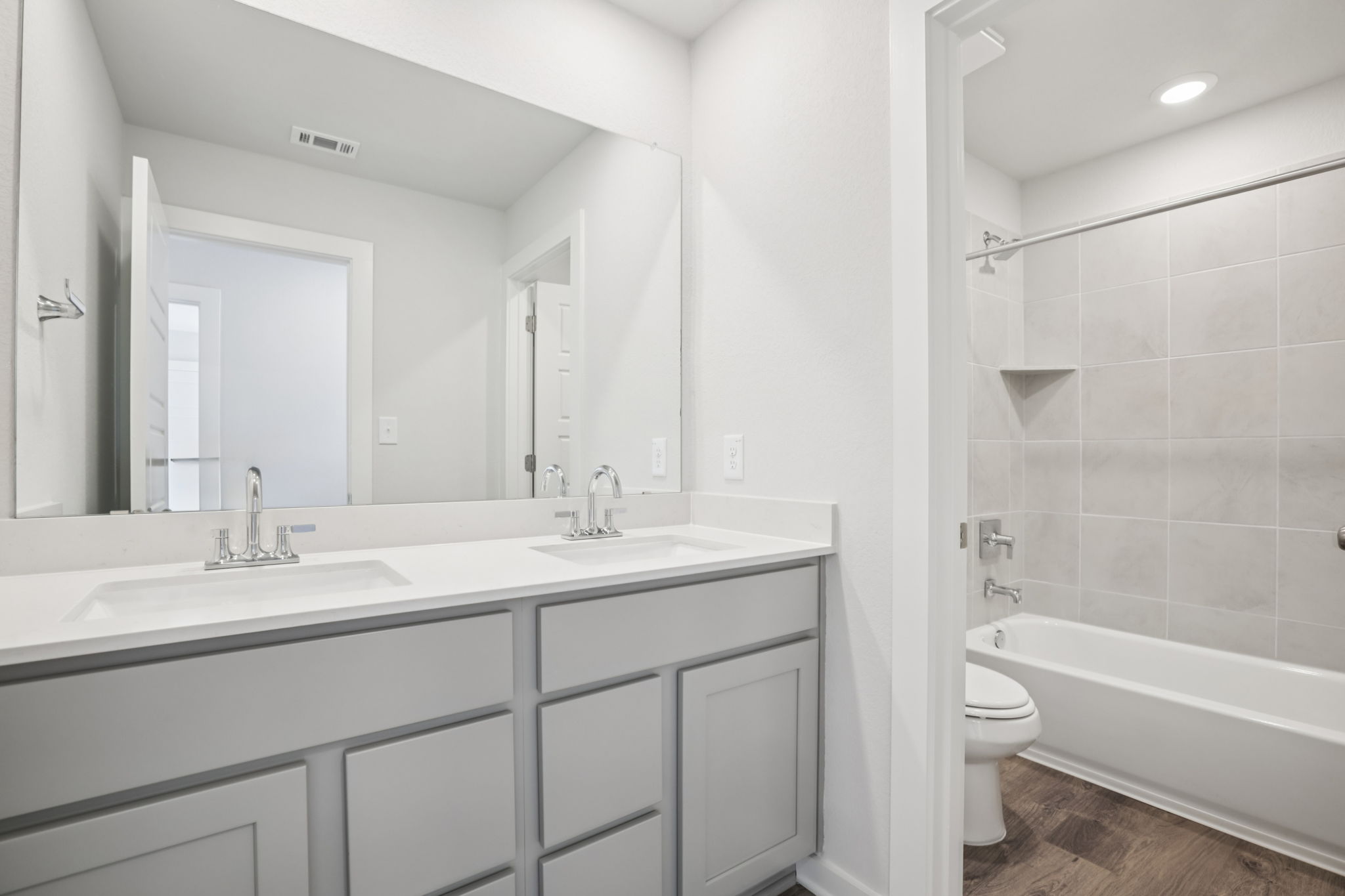 A bathroom with a tub sink and toilet.