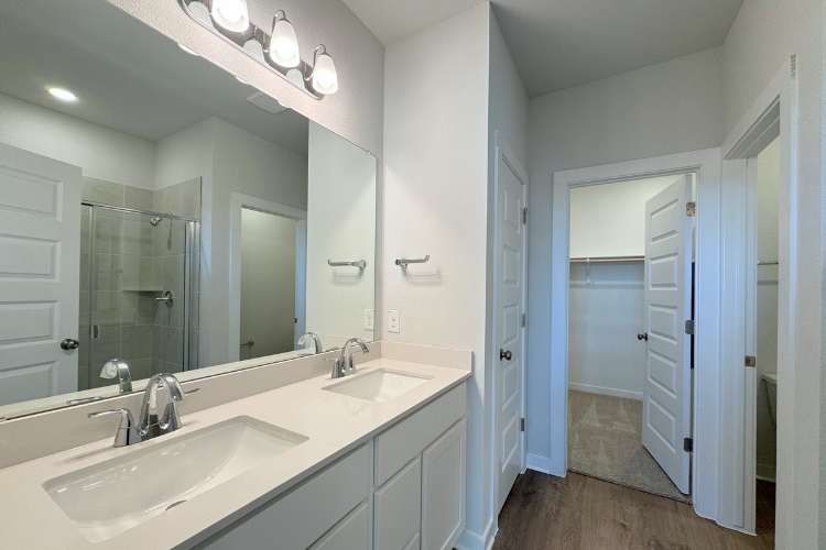 A bathroom with a large mirror.