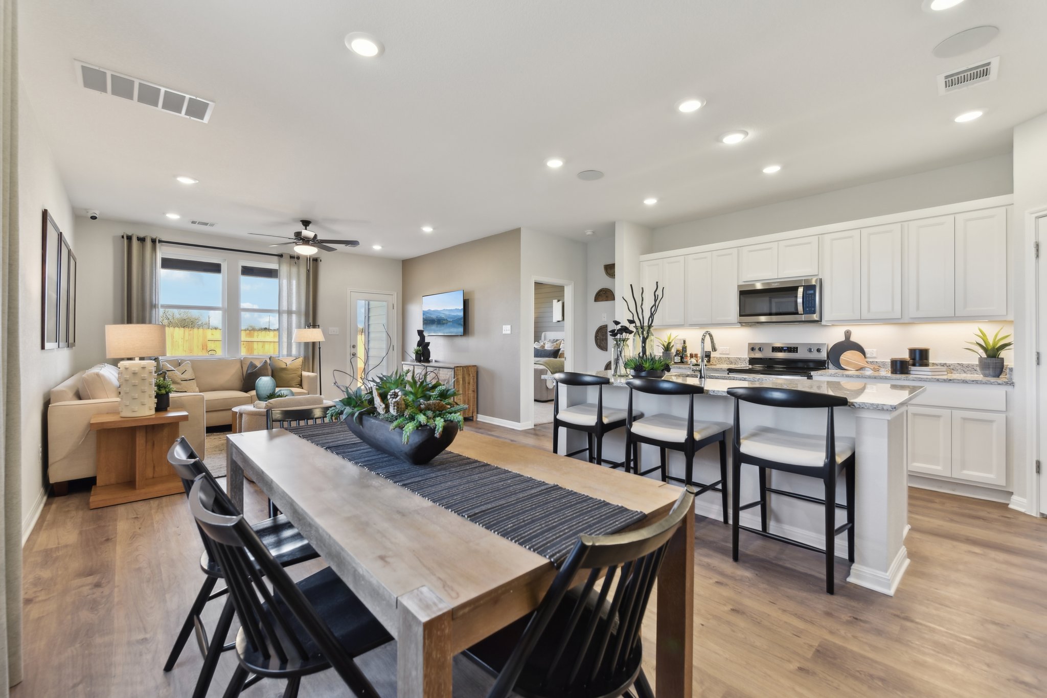 A kitchen with a dining table and chairs.