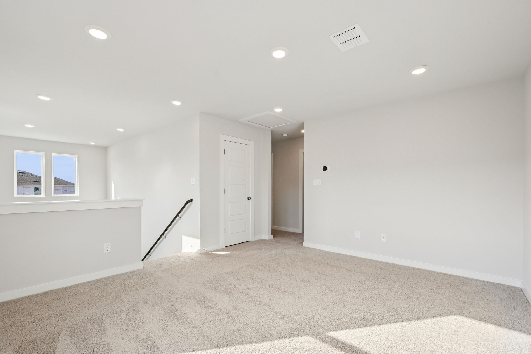 A room with white walls and a carpeted floor.