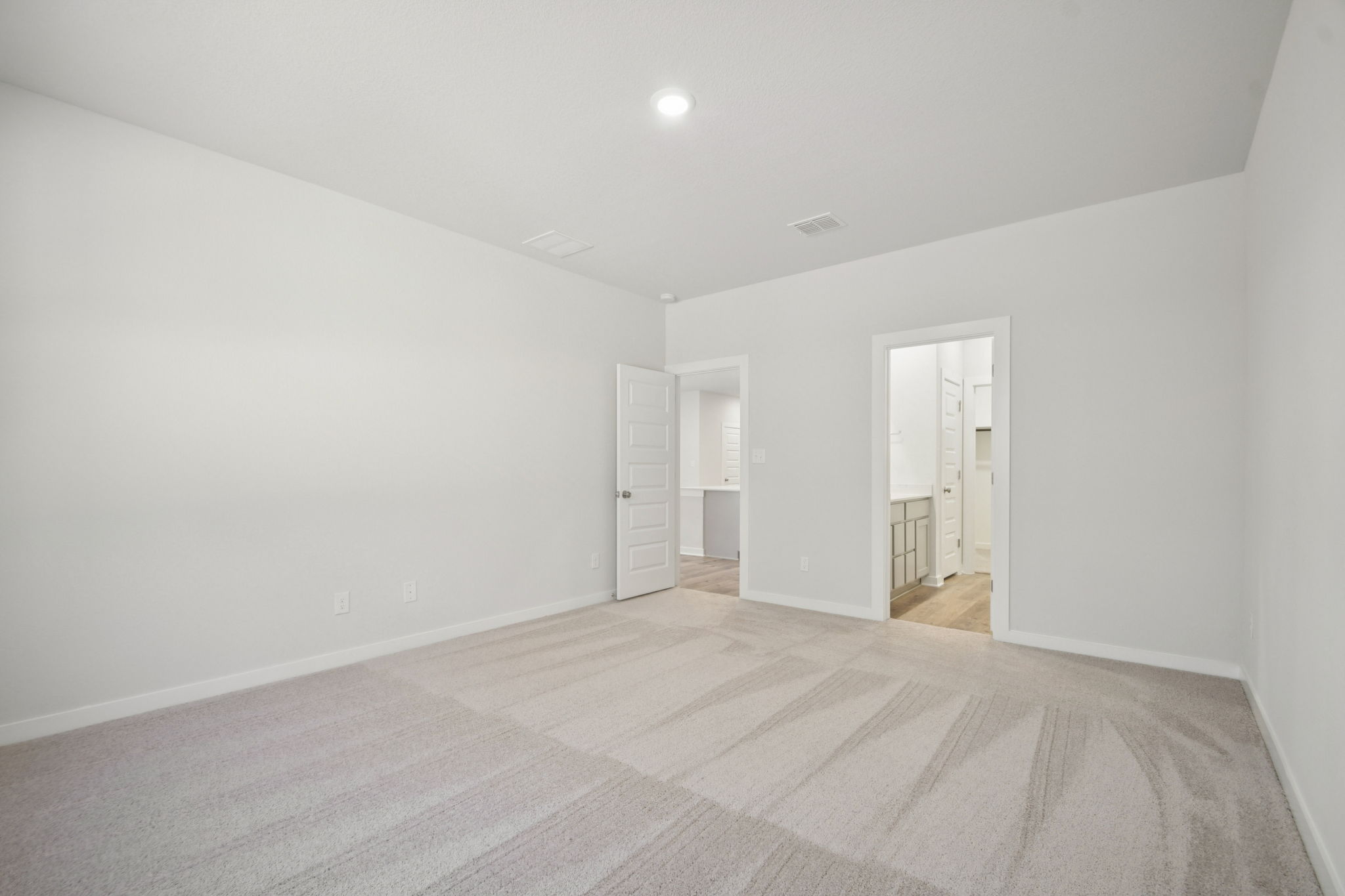 A long hallway with white walls.