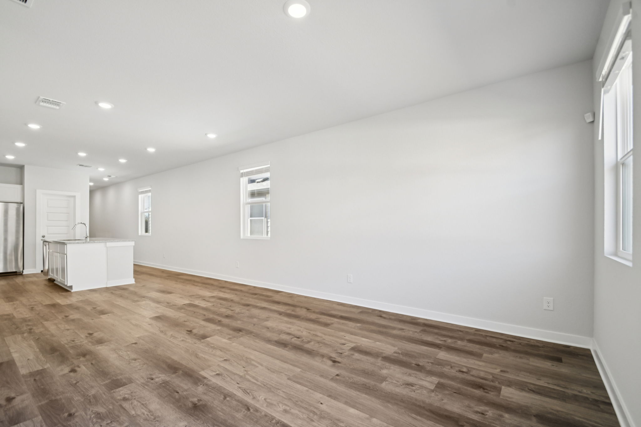 A room with a wood floor and white walls.