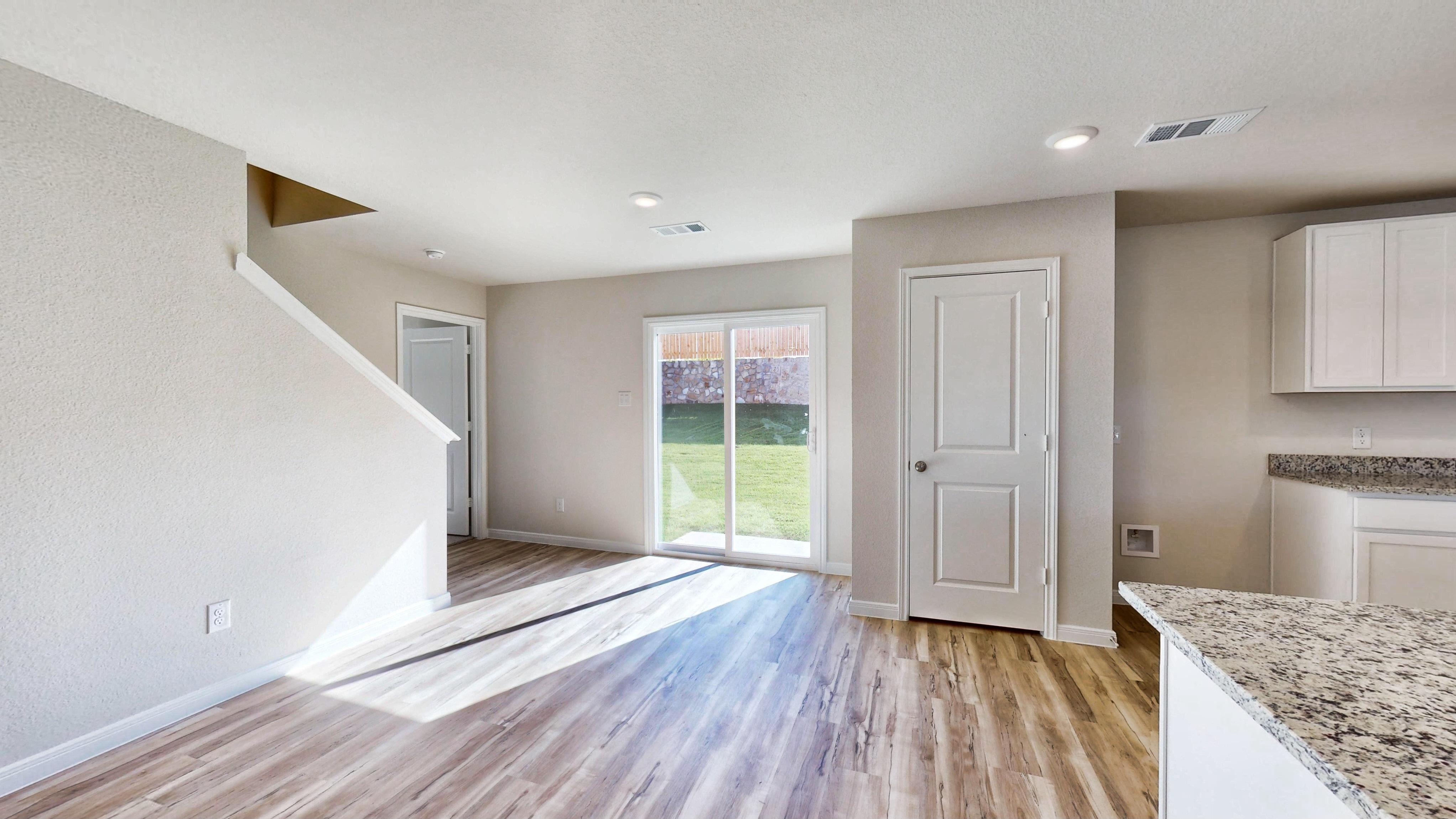 A room with a wood floor and a wood floor with a window.