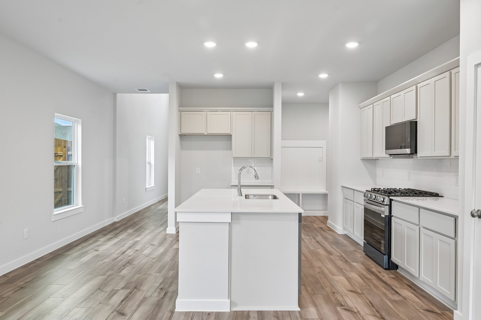 A kitchen with white cabinets.