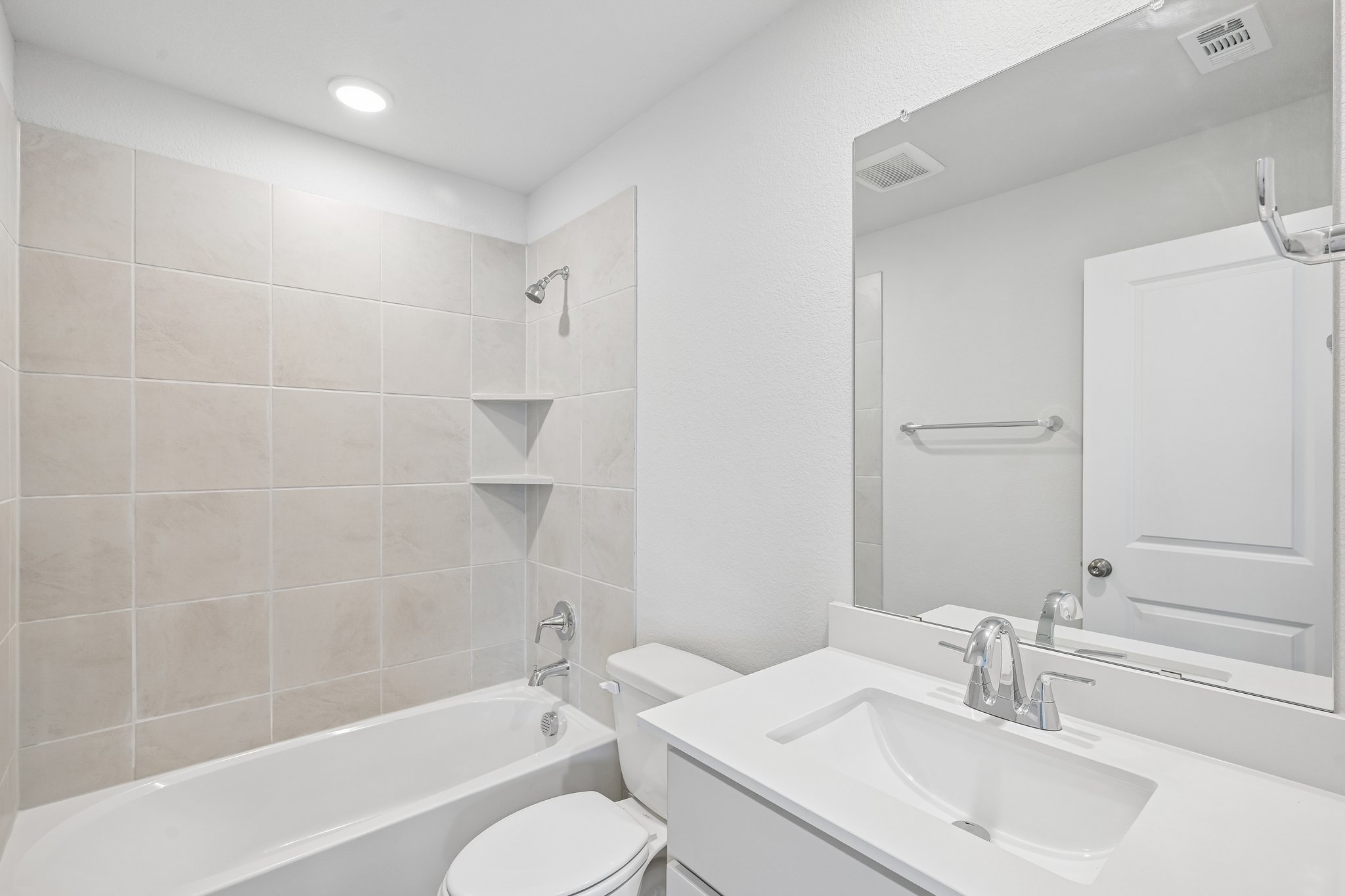 A bathroom with a tub sink and toilet.