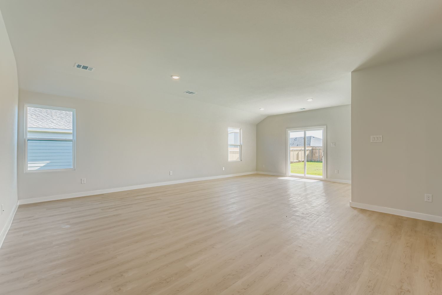 A large empty room with windows.