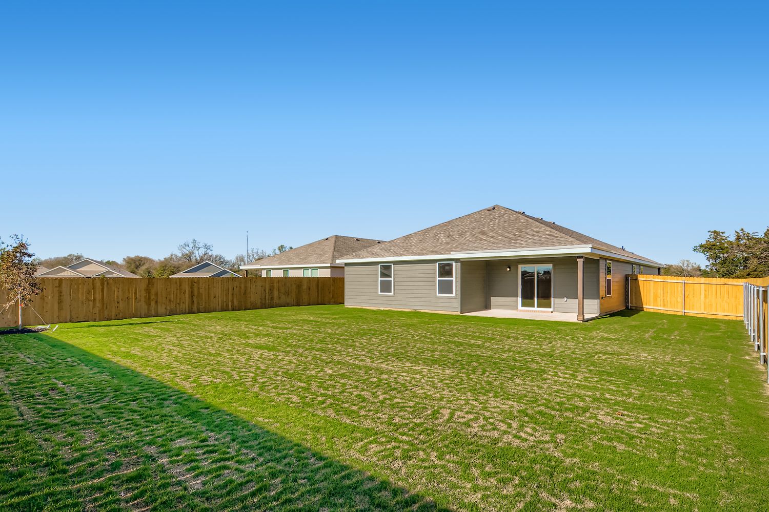 A house with a fence and grass.