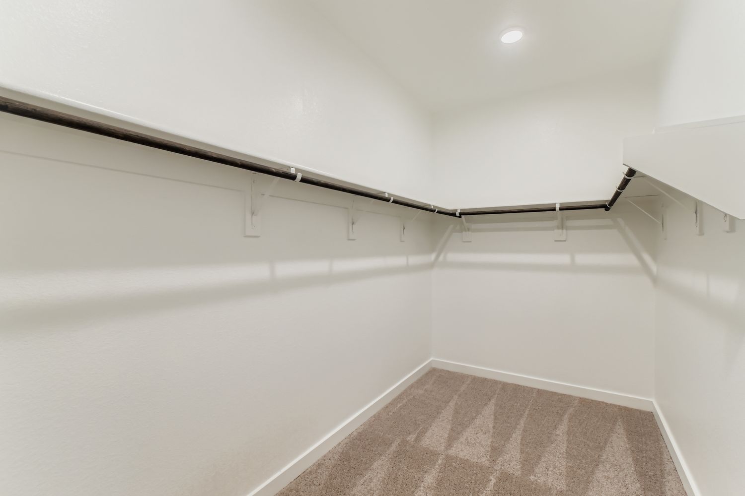 A white hallway with a tile floor.