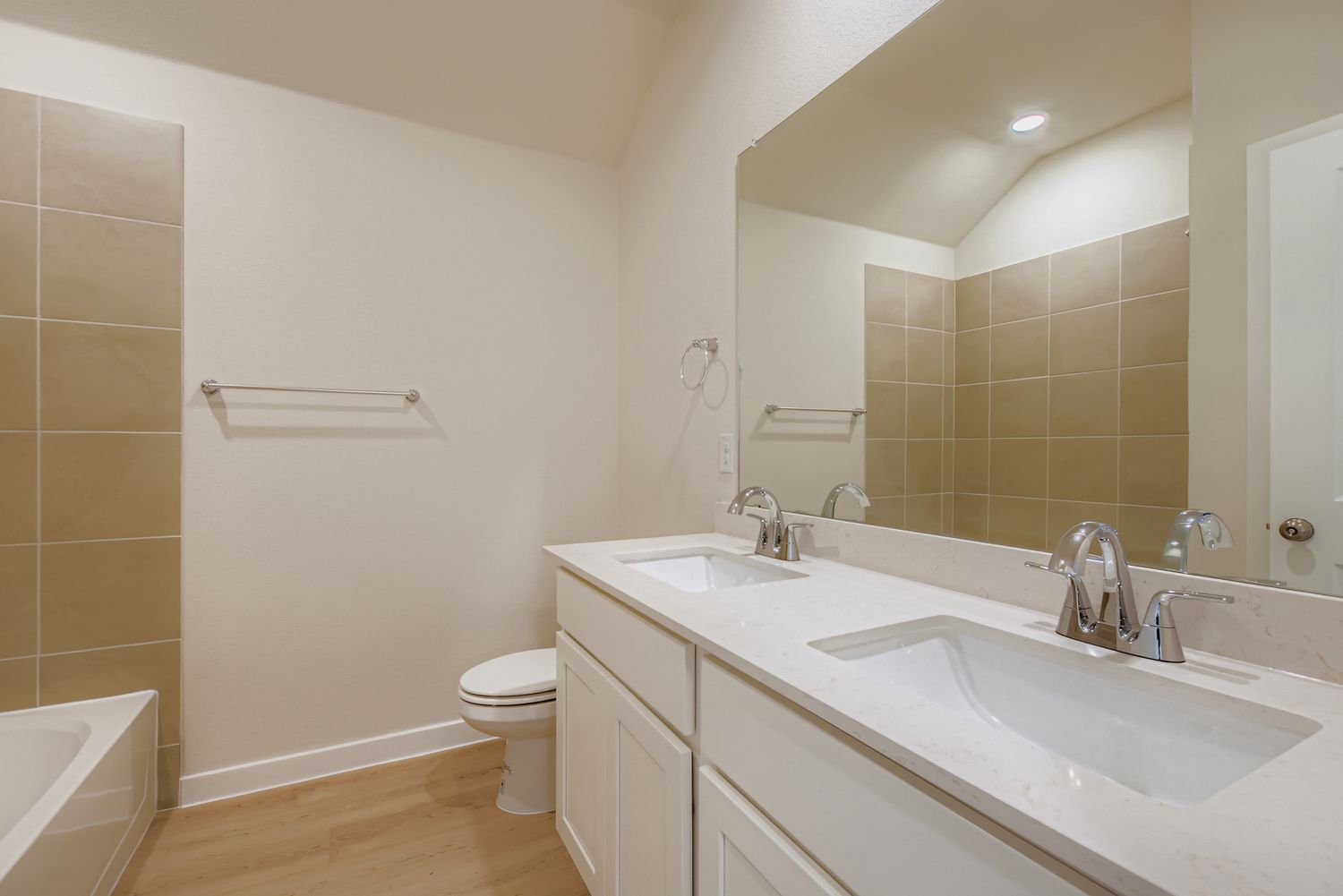 A bathroom with a sink toilet and mirror.