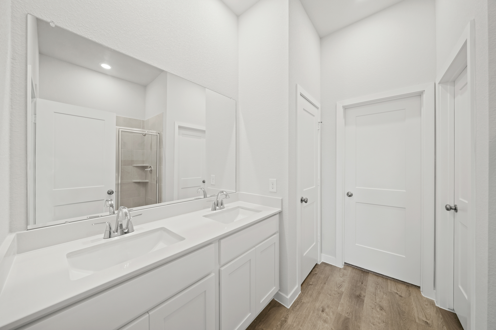 A bathroom with white cabinets.