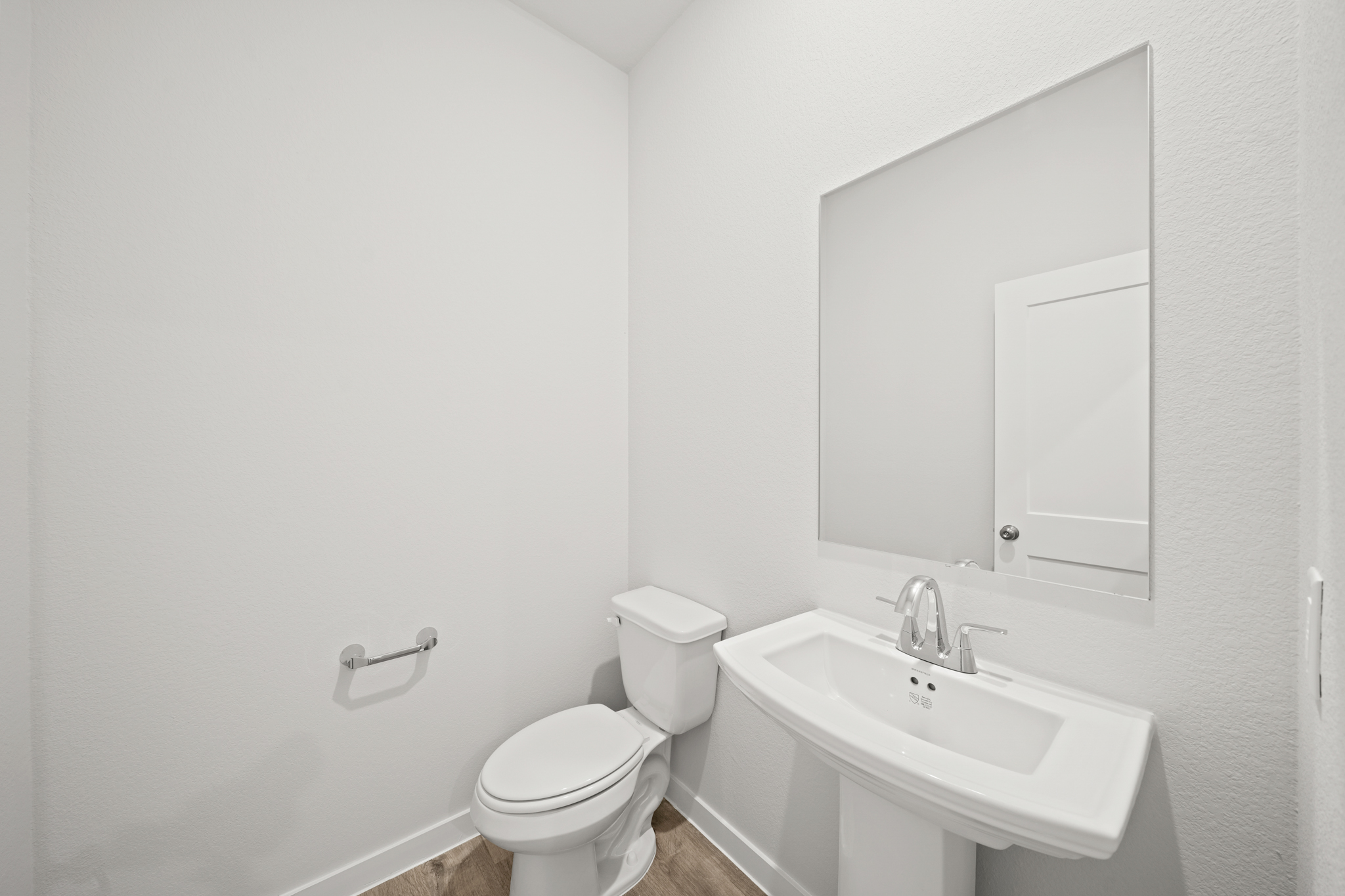 A bathroom with a toilet and sink.