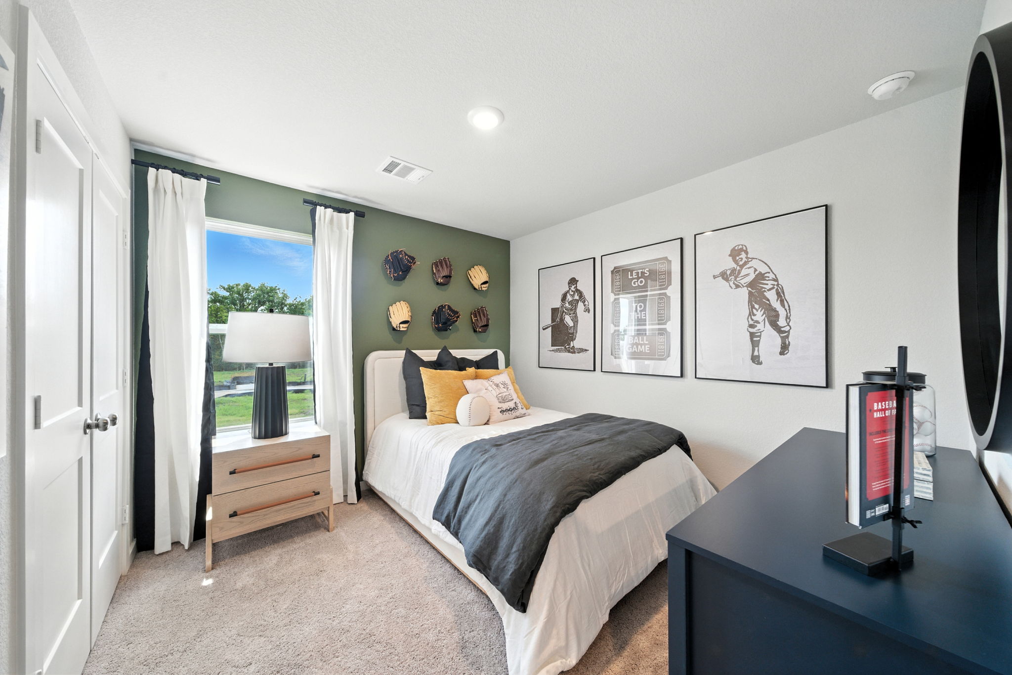 A bedroom with a bed and a desk.