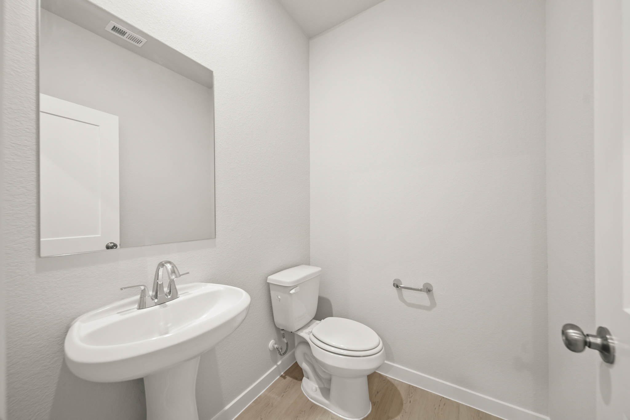 A bathroom with a toilet and sink.