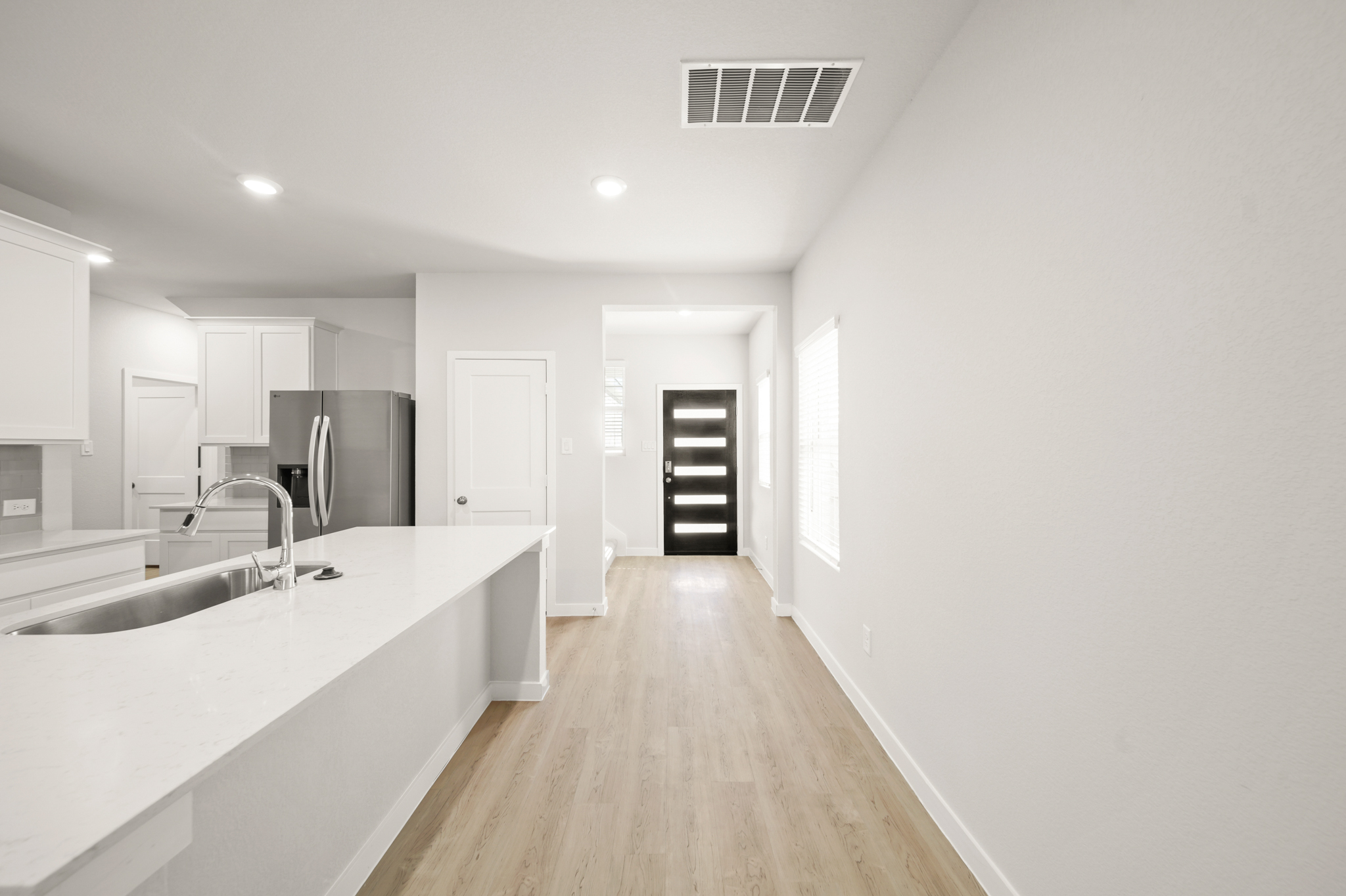 A kitchen with white cabinets.