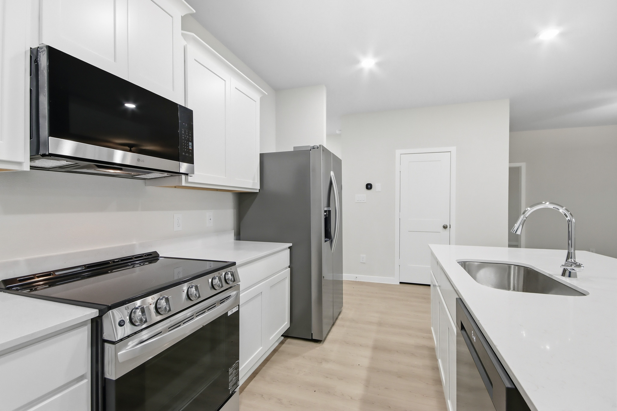 A kitchen with white cabinets.