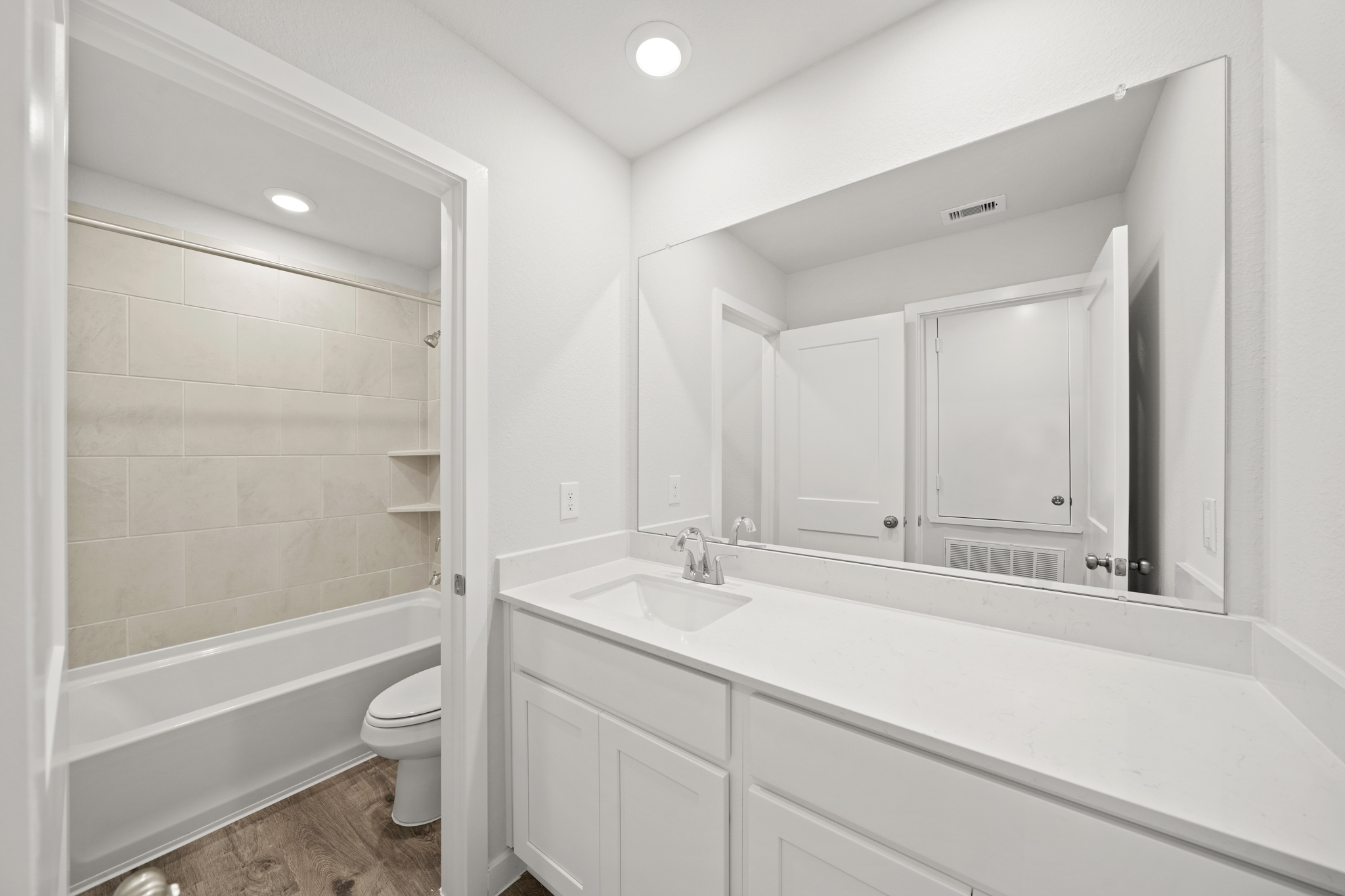 A bathroom with a tub sink and toilet.
