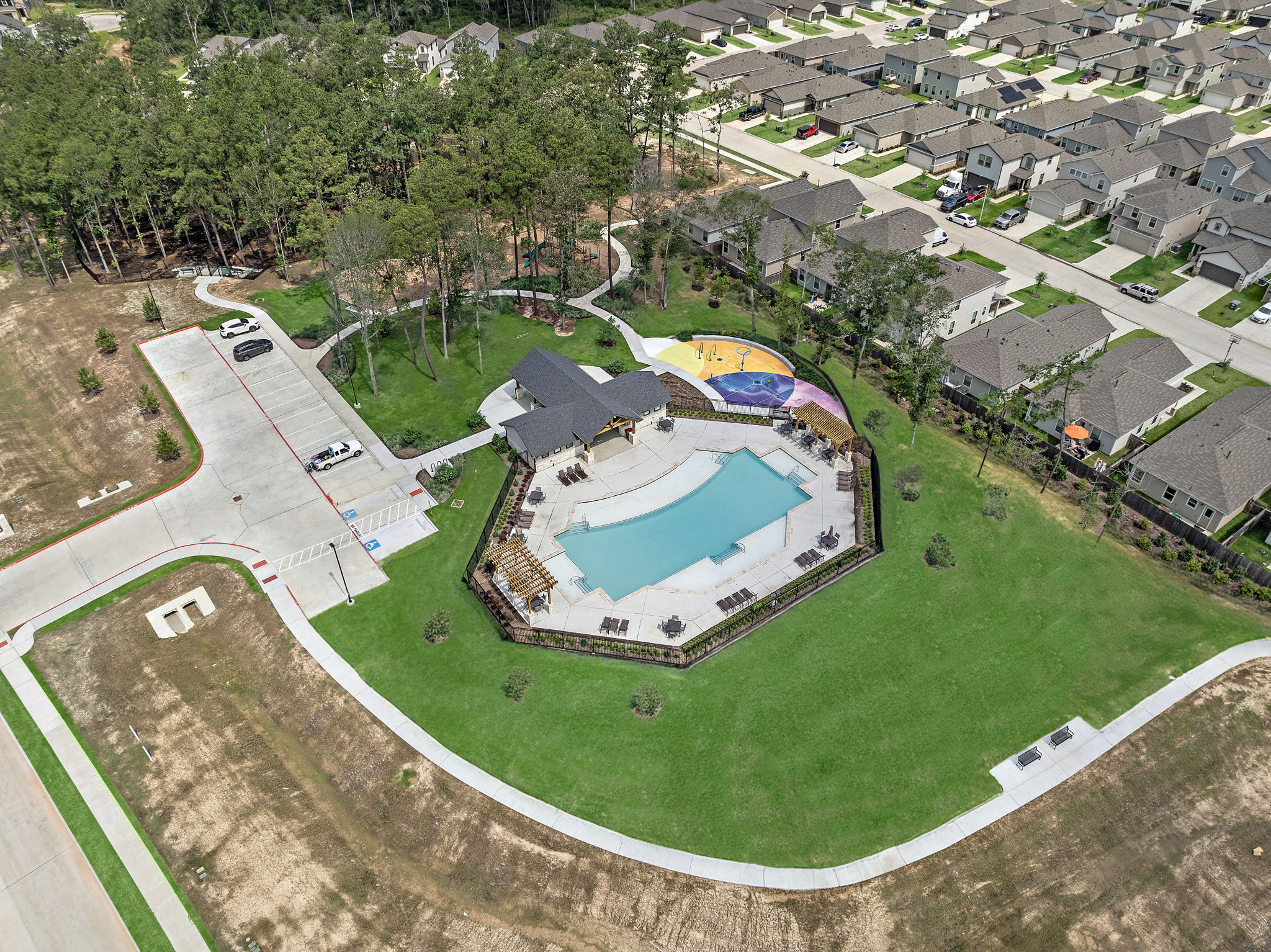 A large building with a green field.