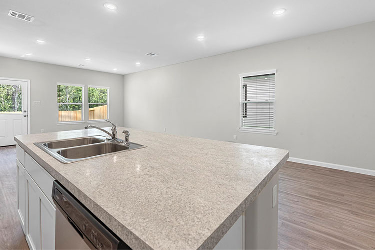 A kitchen with marble counters.