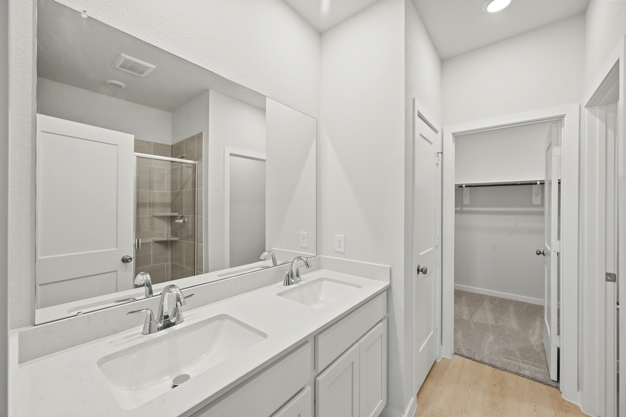 A bathroom with a large mirror.