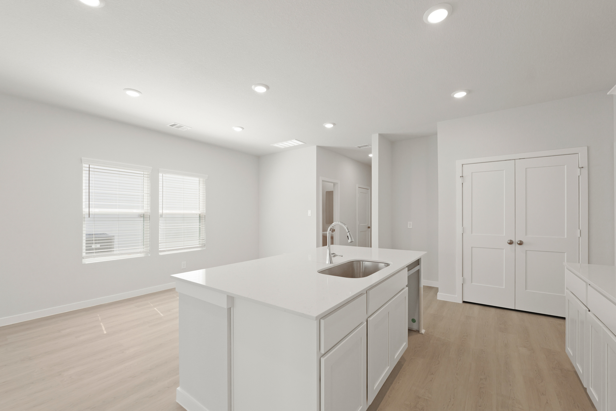 A bathroom with white cabinets.