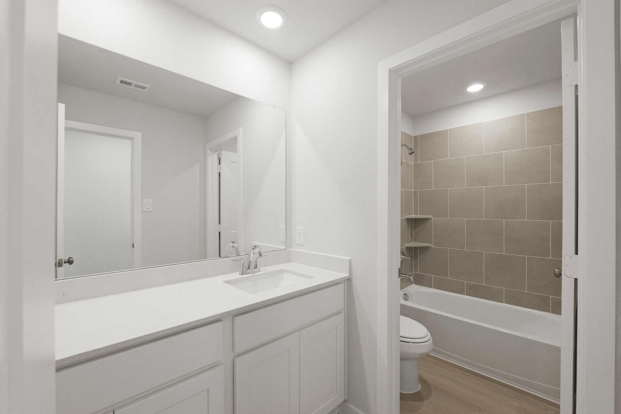 A bathroom with a sink toilet and shower.