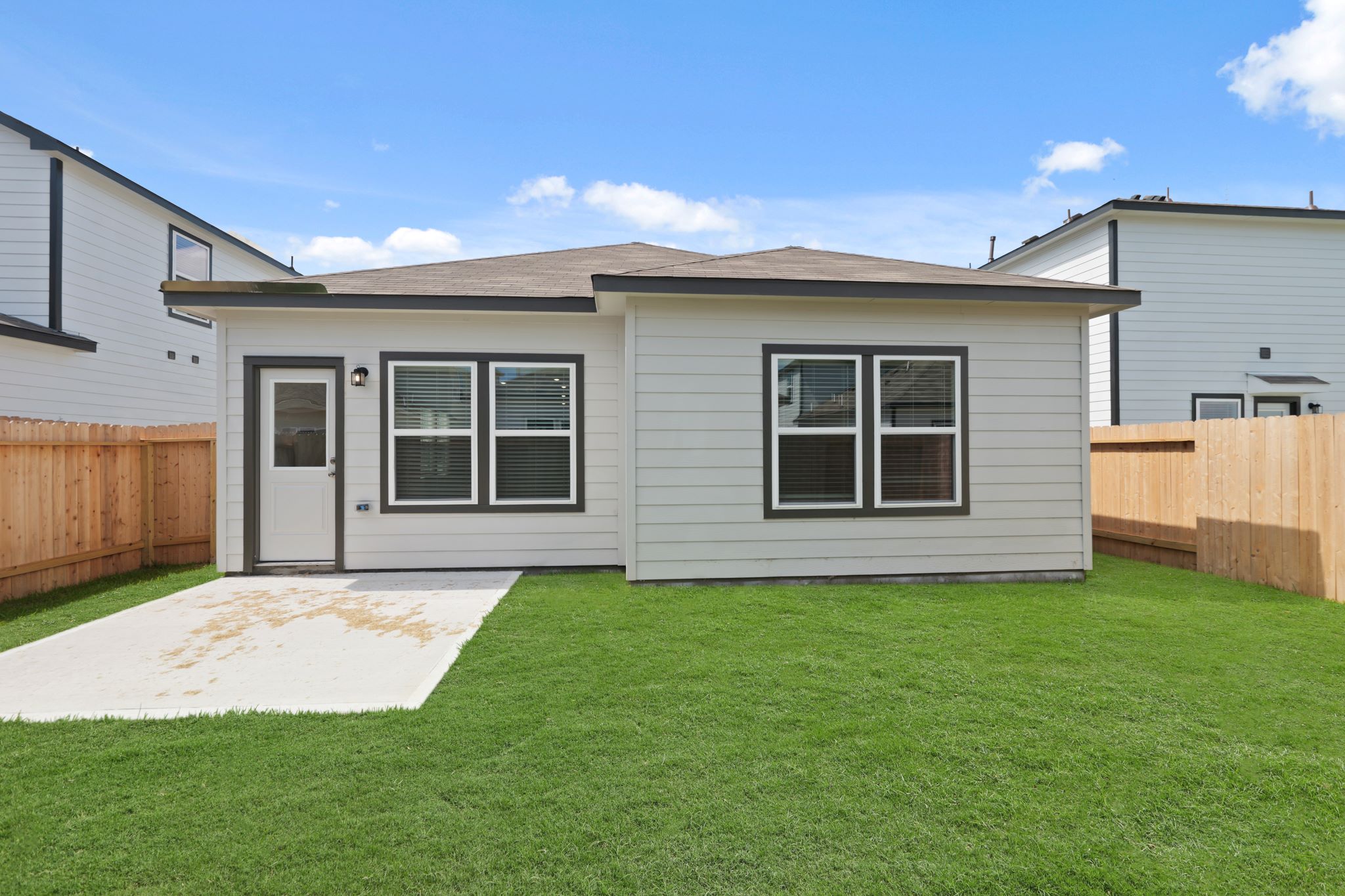 A house with a fence and grass.