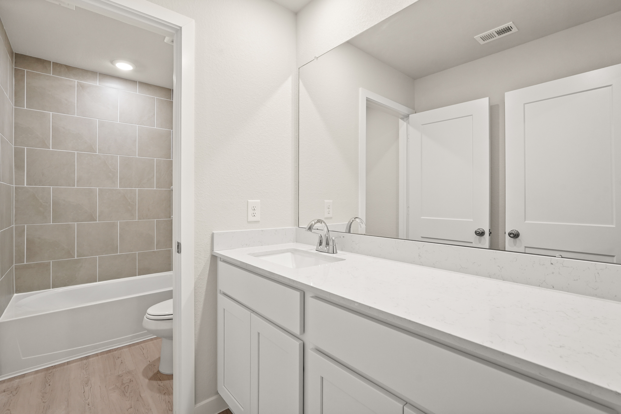 A bathroom with a tub sink and toilet.
