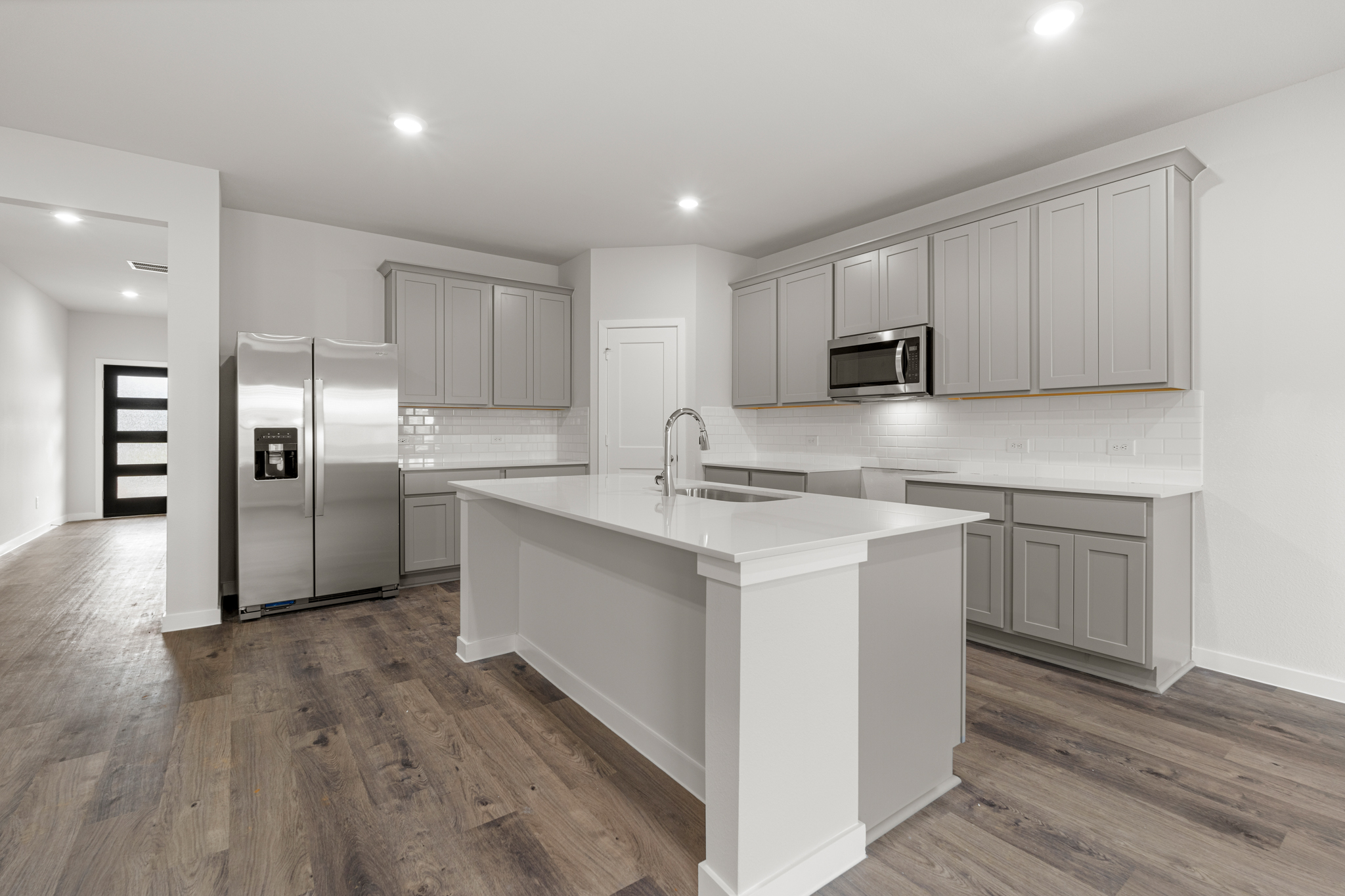 A kitchen with white cabinets.