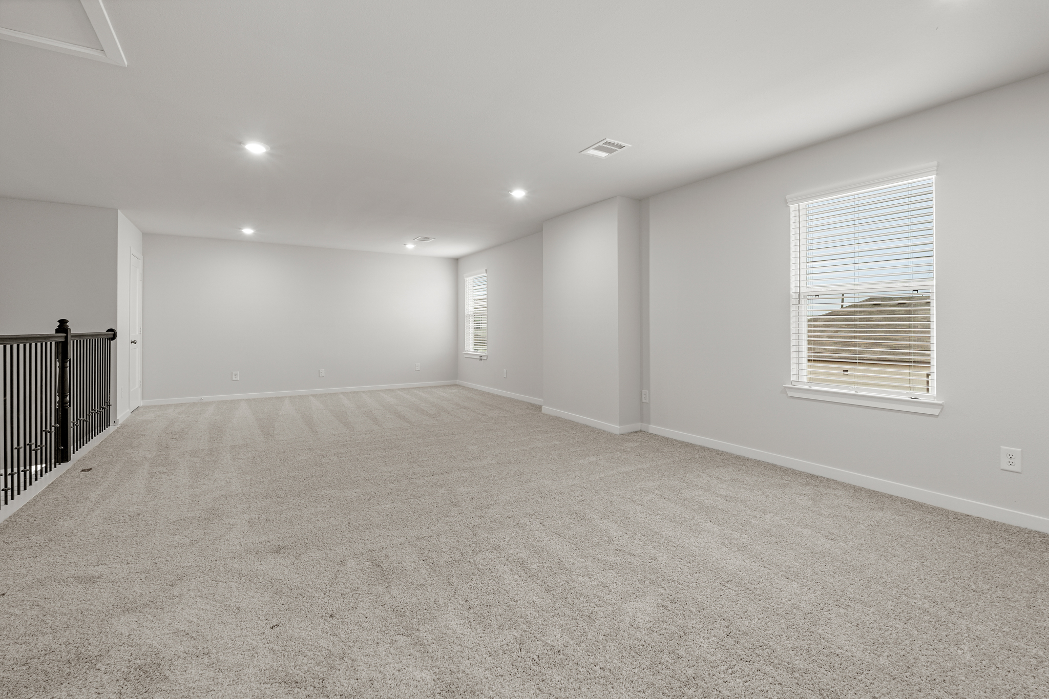 A room with a carpet and a window.