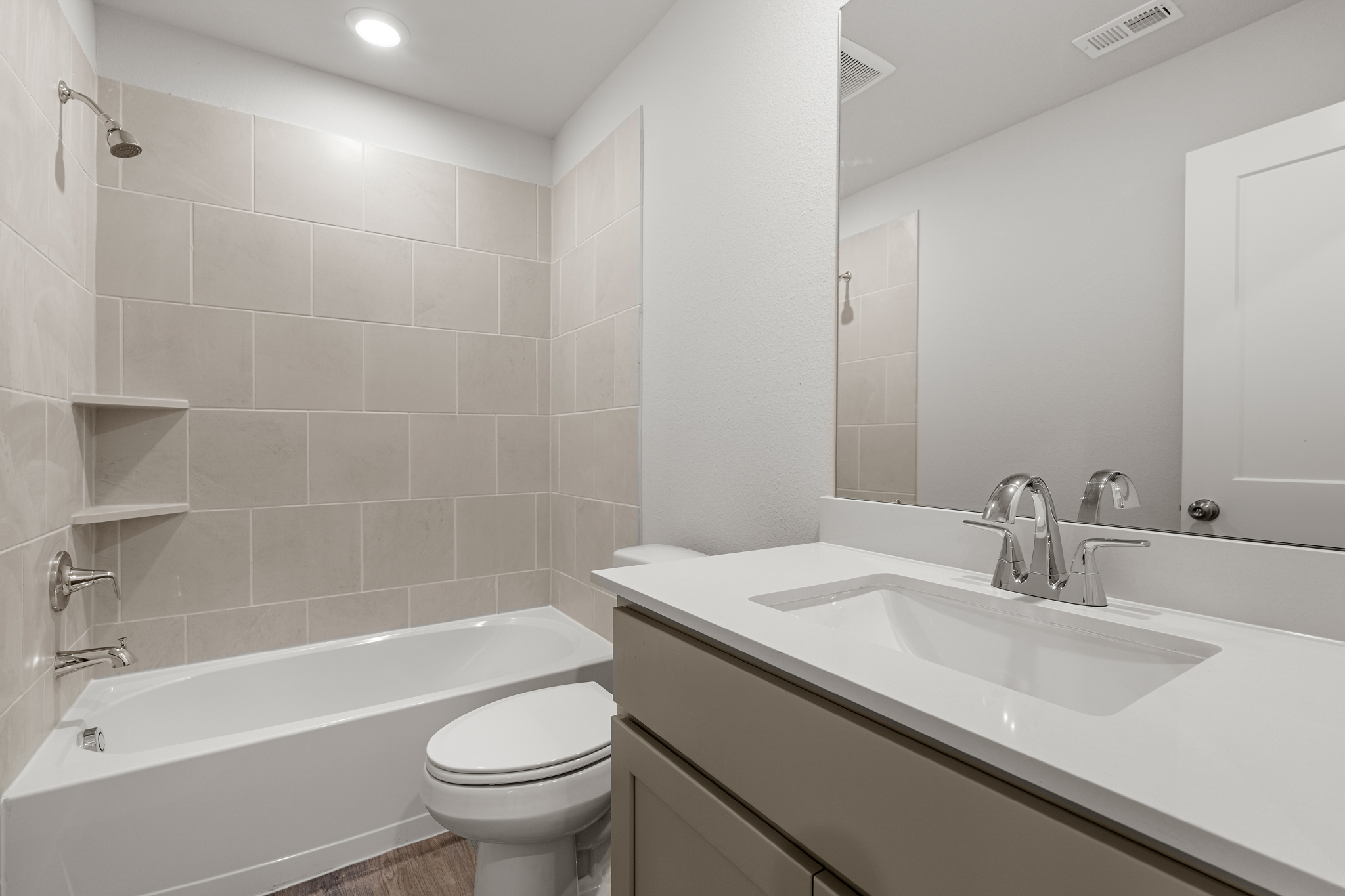 A bathroom with a tub sink and toilet.