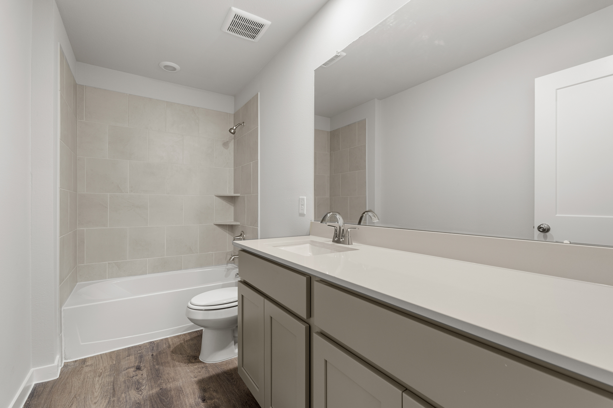 A bathroom with a tub sink and toilet.