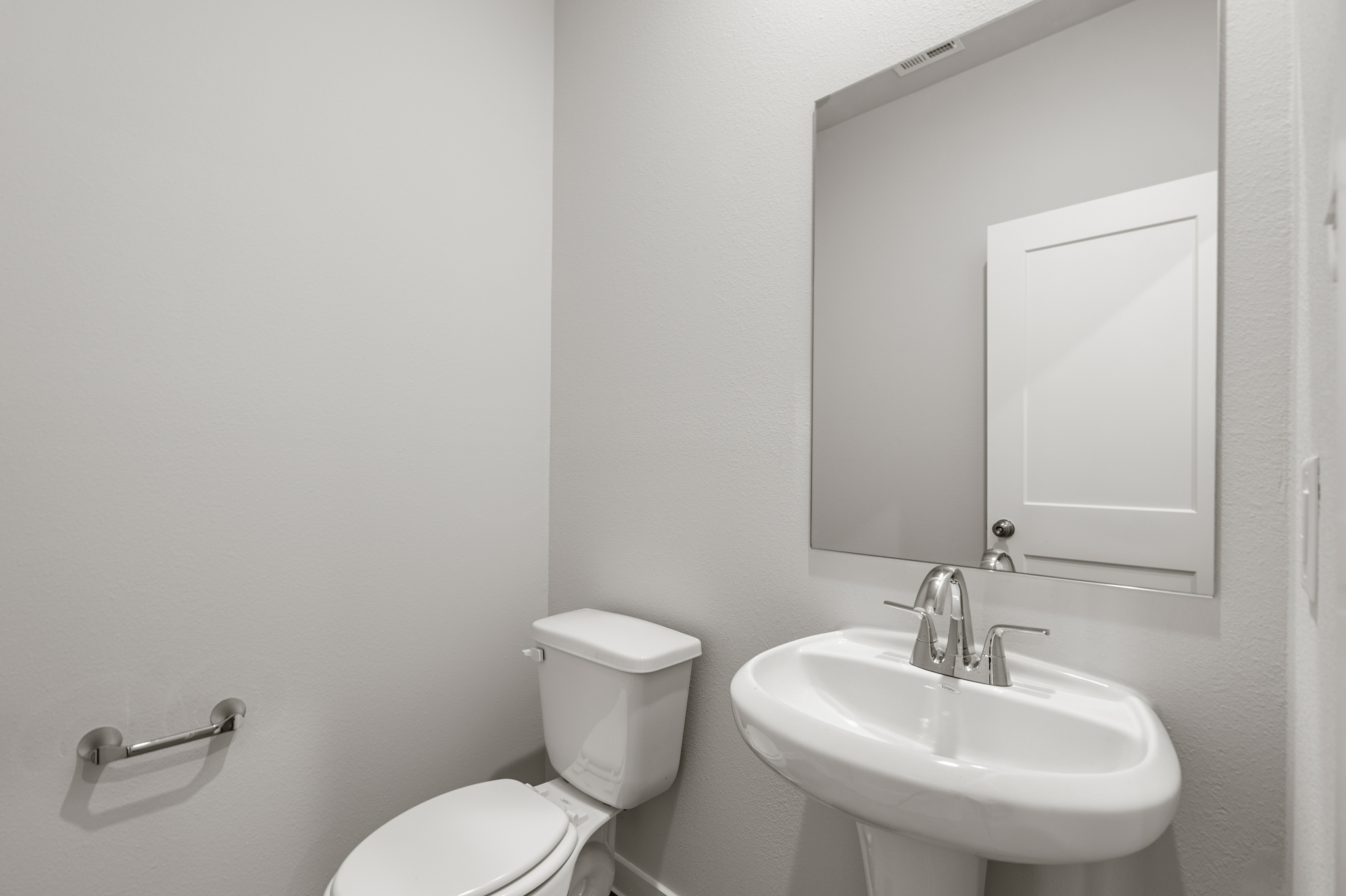 A bathroom with a sink and toilet.