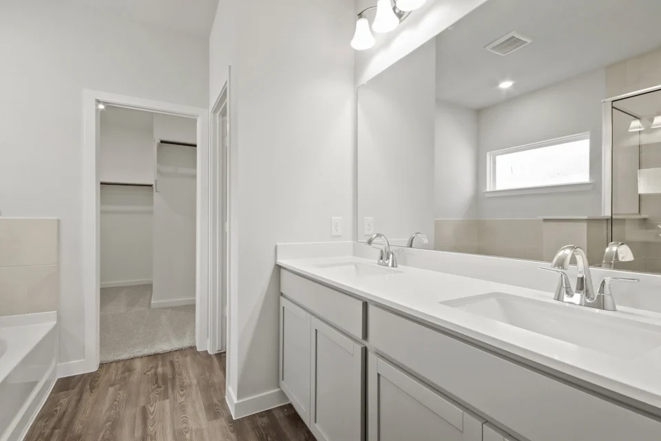 A bathroom with a large mirror.