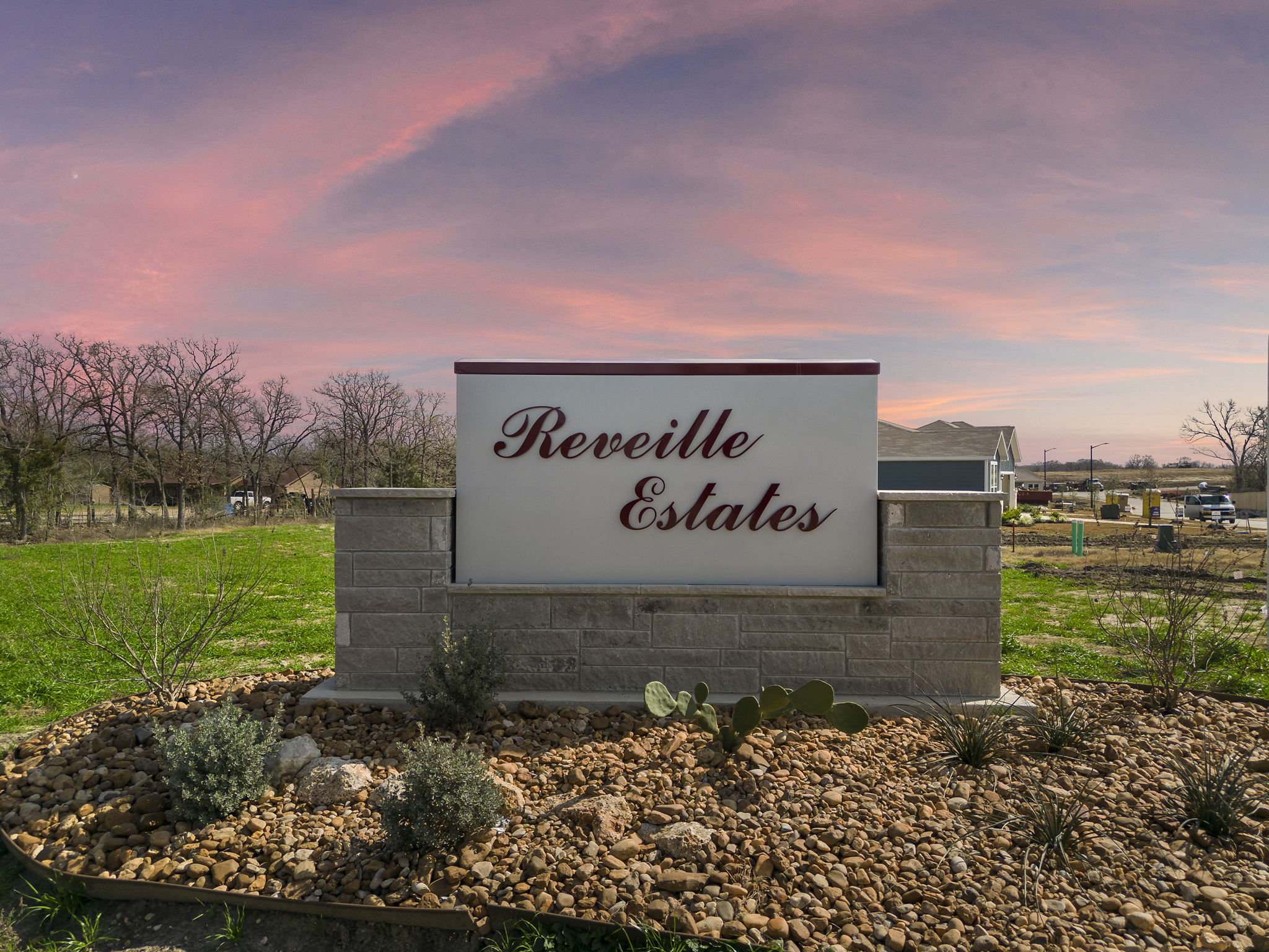 A sign on a stone wall.