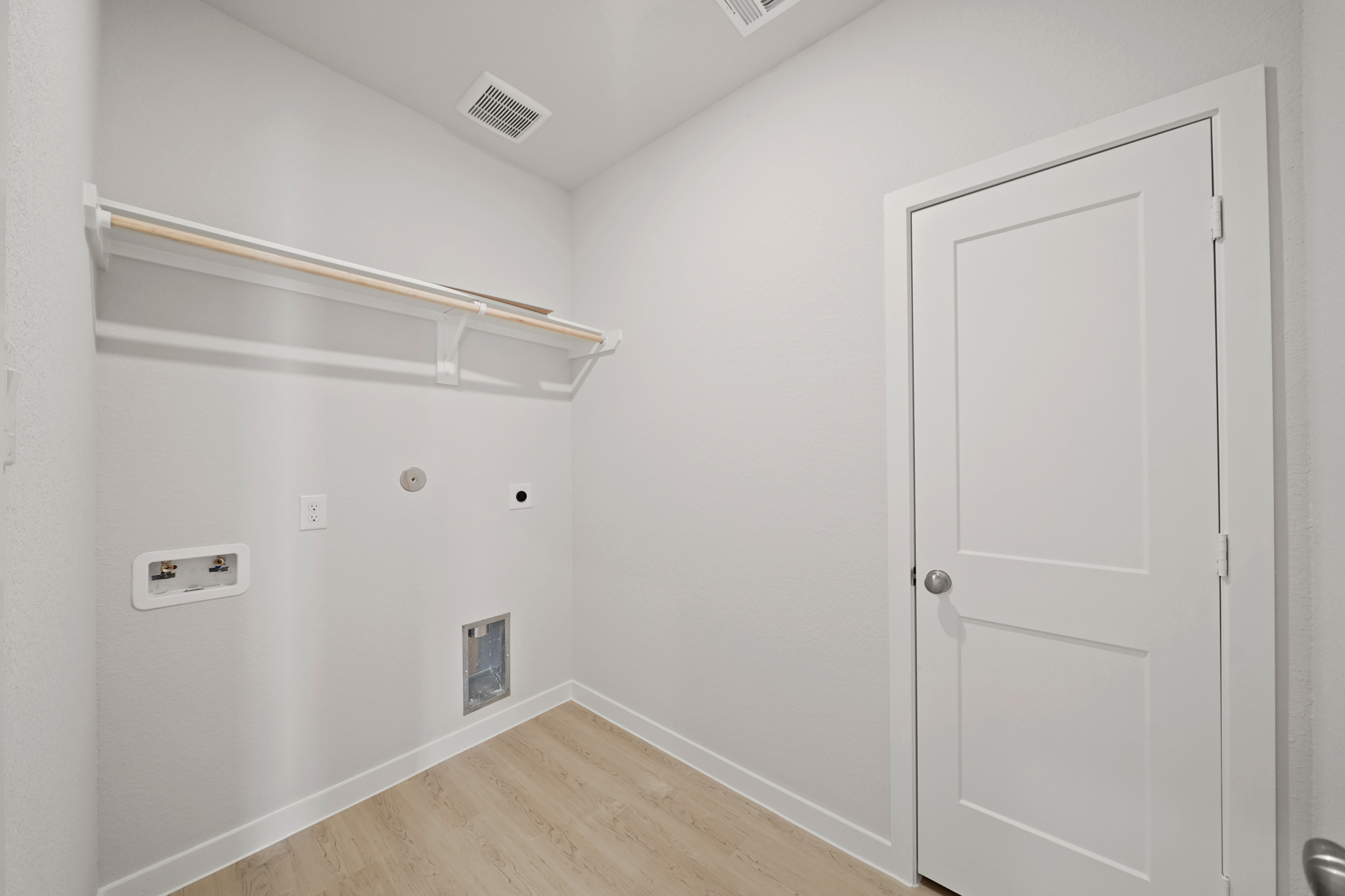 A white room with a white door.