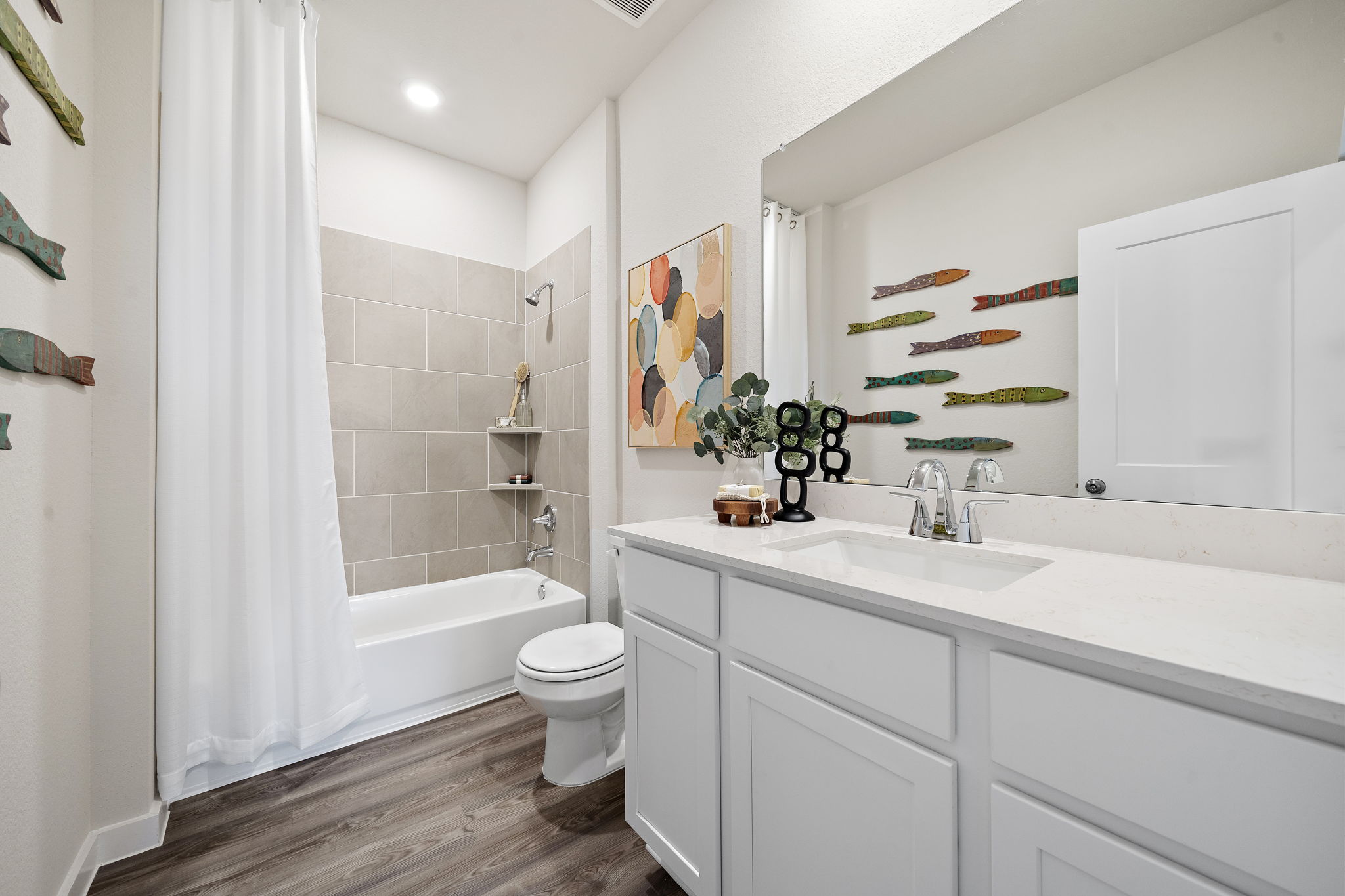 A bathroom with a tub sink and toilet.