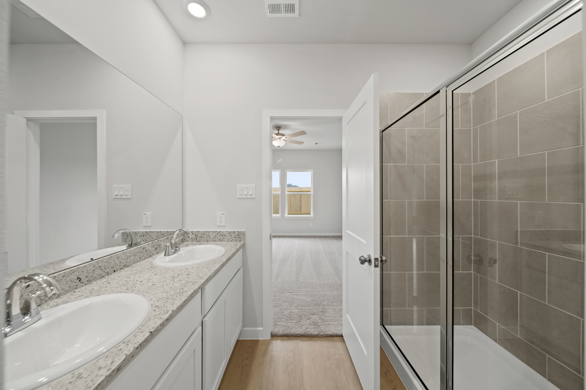 A bathroom with a sink and a shower.