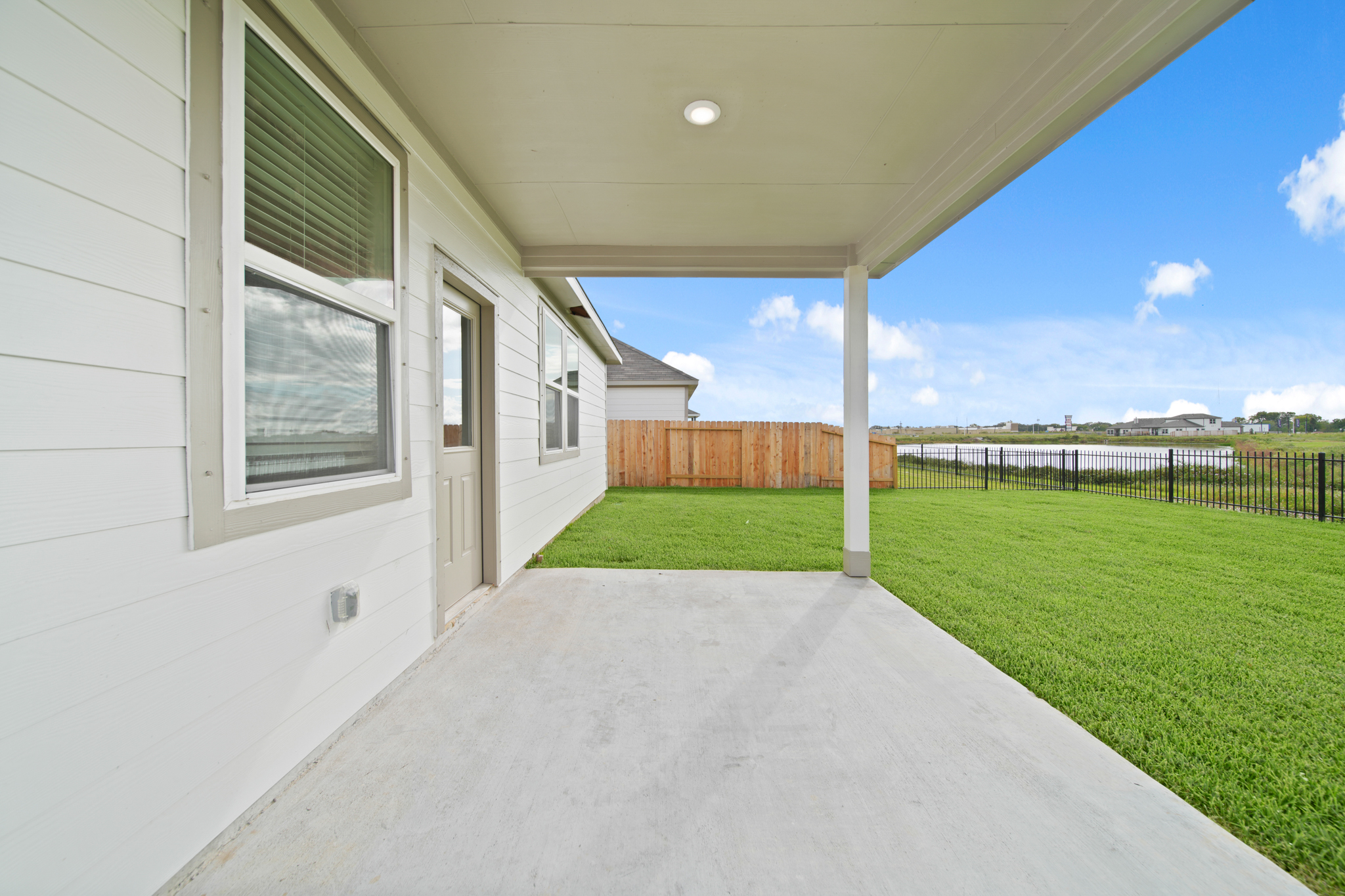 A house with a fence and grass.