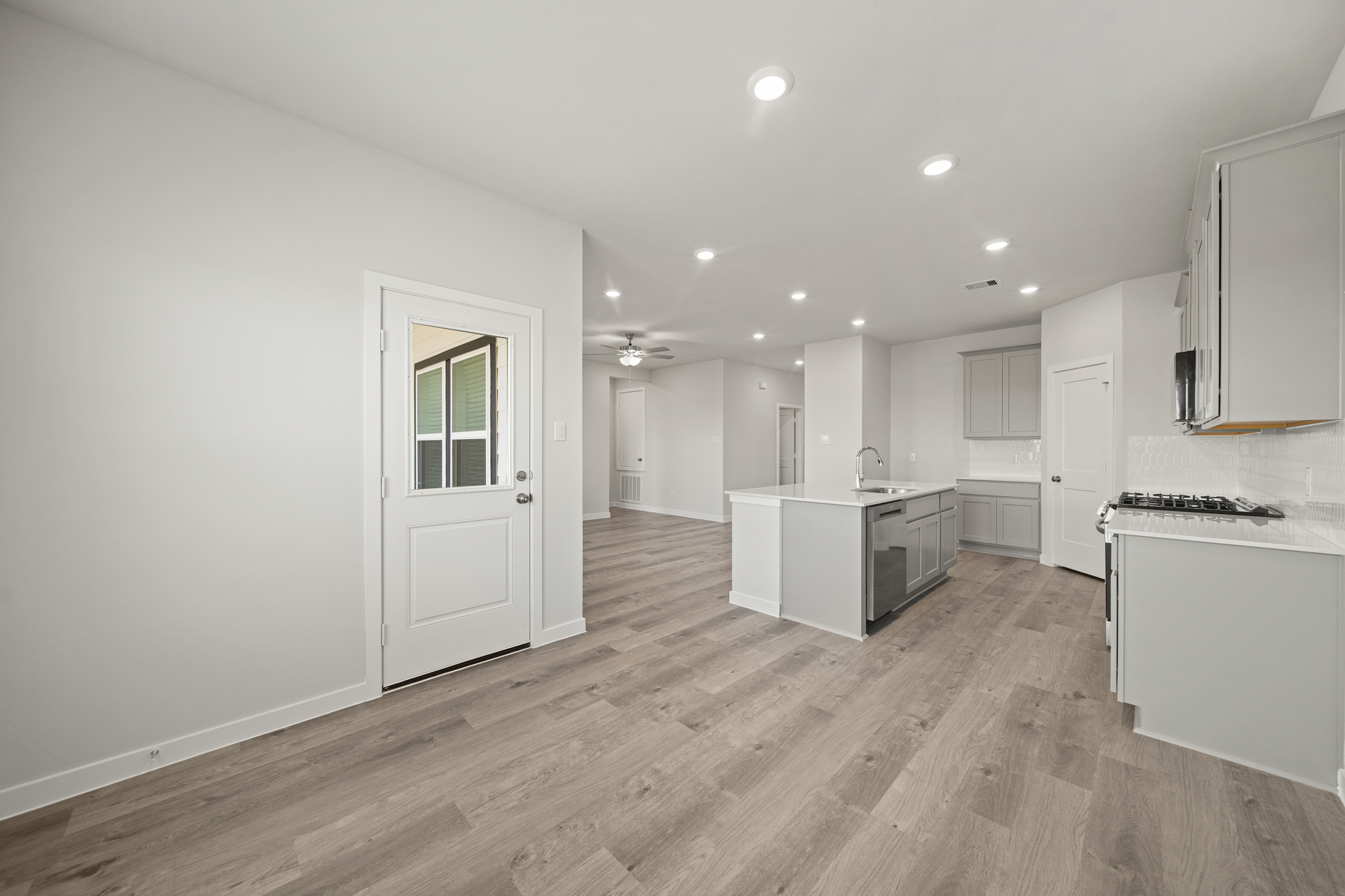 A large kitchen with white cabinets.