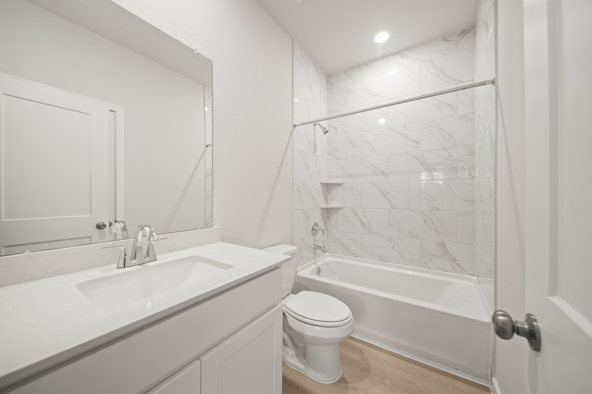 A bathroom with a tub sink and toilet.