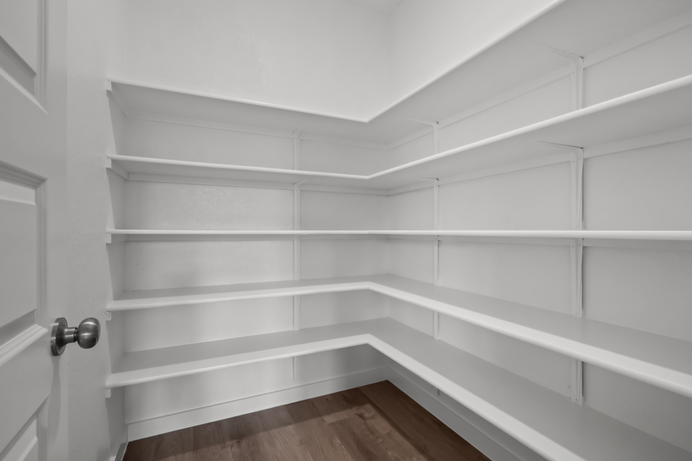 A white wall with a door.
