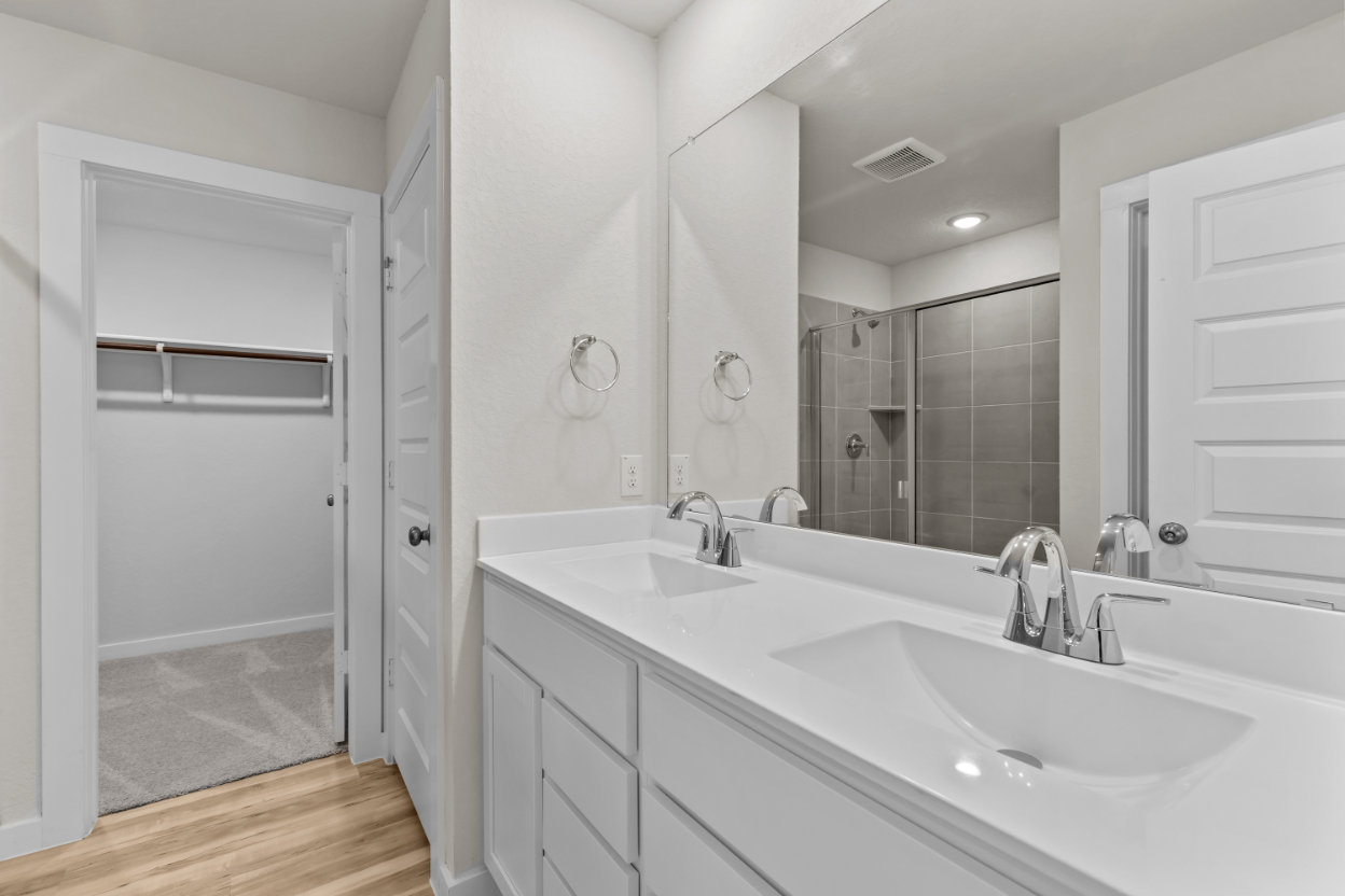 A bathroom with a large mirror.