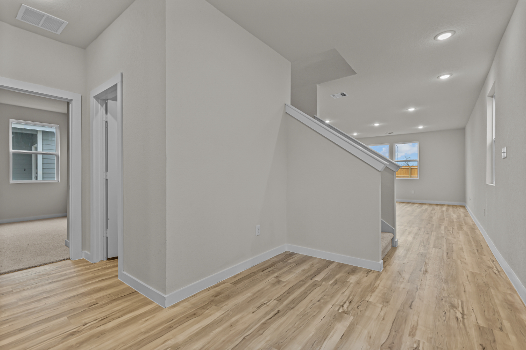 A room with a wood floor and white walls.