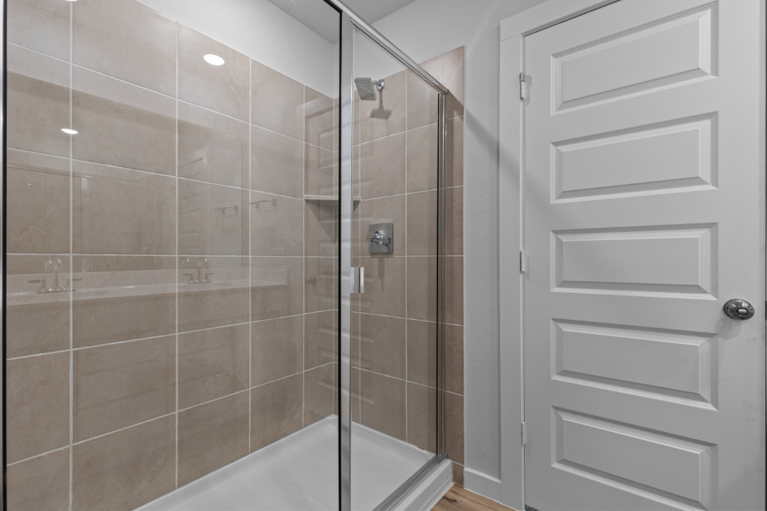 A shower with a glass door.